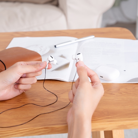 you can use your Airpods when Podstring is in use, either to adjust volume or answer the call